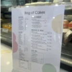 Bag of Cakes menu USA prices 2026 featuring cakes, pastries, cream puffs and specialty drinks