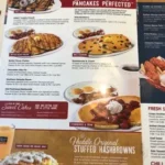 Huddle House menu featuring breakfast platters, golden waffles, burgers, and homestyle dinners