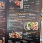 Saltgrass Steak House menu with steaks, barbecue ribs, seafood, burgers, and side dishes.