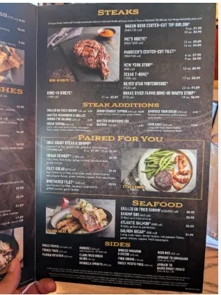 Saltgrass Steak House menu with steaks, barbecue ribs, seafood, burgers, and side dishes.